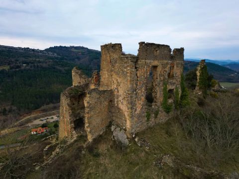 Photo of Coustaussa Castle with a view of Rennes-le-Château and the Sals Valley in the background.